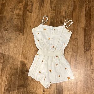 White romper with floral decorations